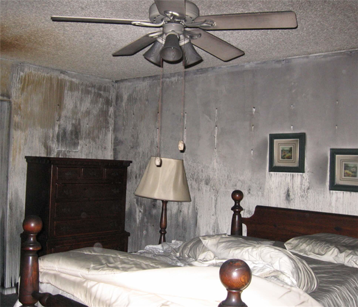 A bedroom that has been on fire.