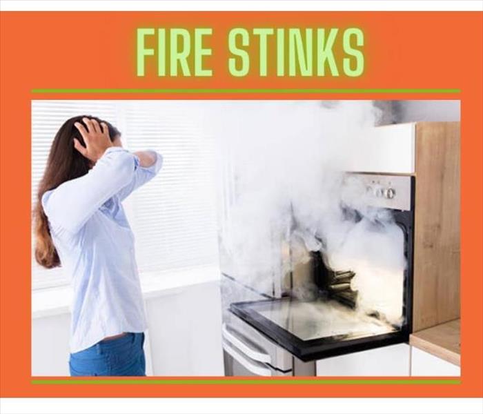 woman looking at smoke coming from oven